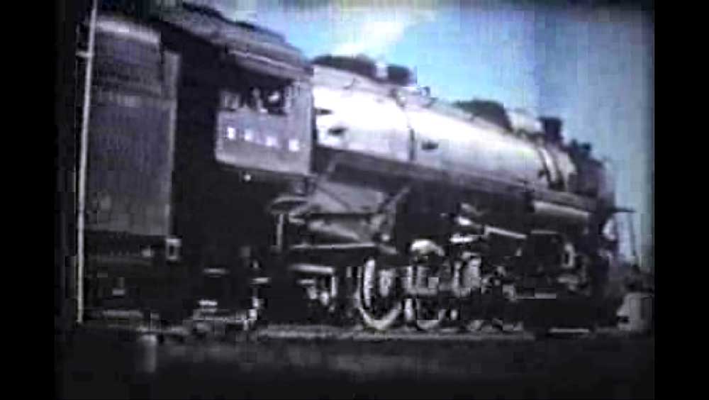 Steam locomotive going away from camera