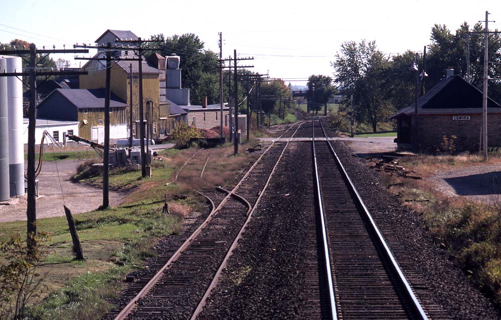 track with grass and telephone poles on side