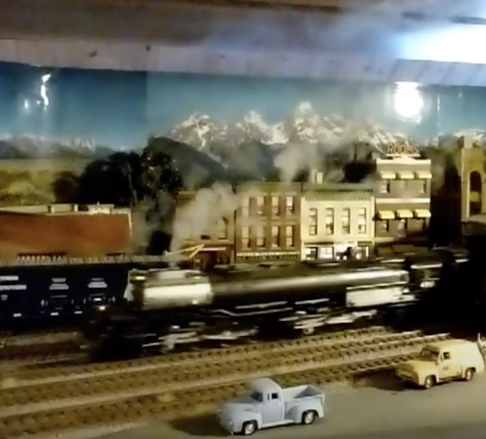 A model Big Boy 4-8-8-4 locomotives exits an engine shed.