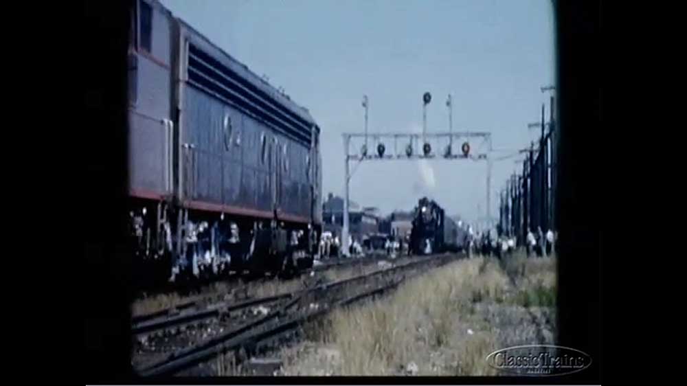 Diesel locomotive approaching signal bridge