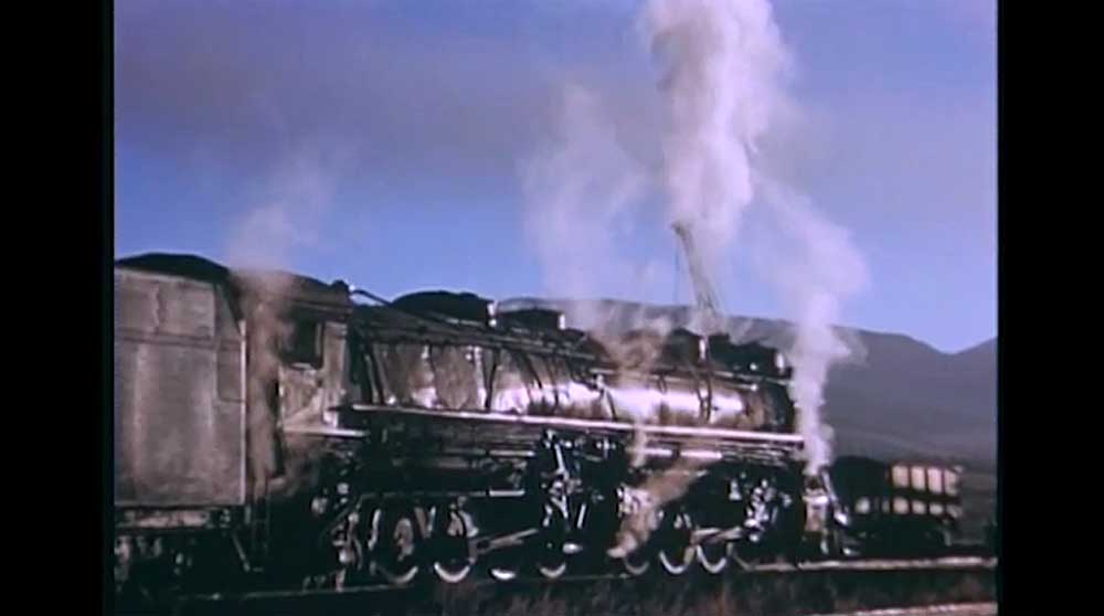 Steam locomotive going away from camera