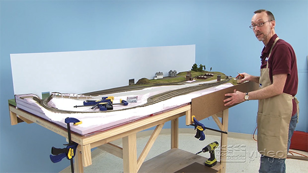 David Popp next to a half built layout.