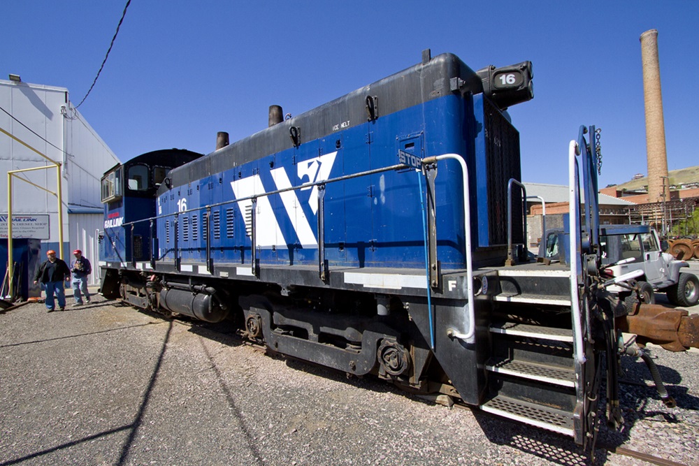 Blue switching locomotive viewed up close with a wide-angle lens.