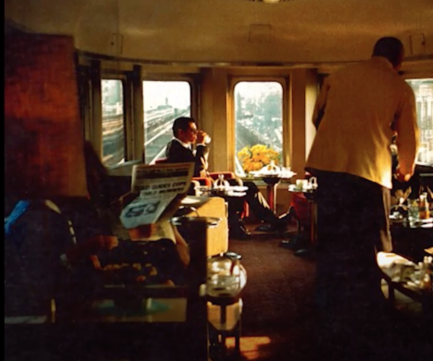 People lounging in a business attire in a passenger train car.
