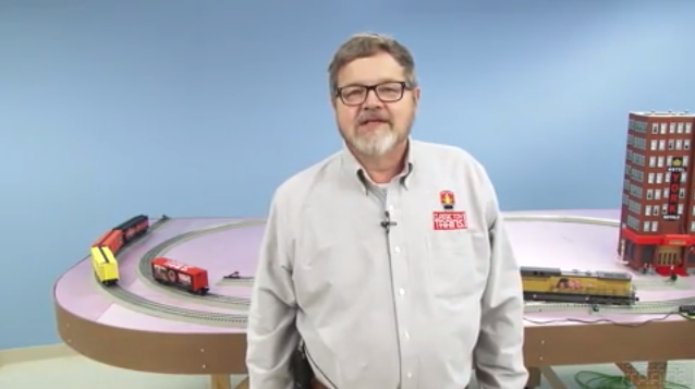 Bob Keller standing in front of an O gauge layout