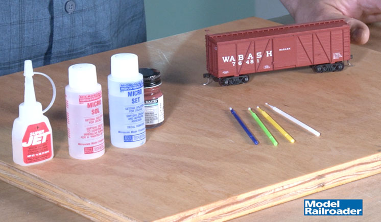 Adhesvies, microbrushes, and a boxcar on a workbench