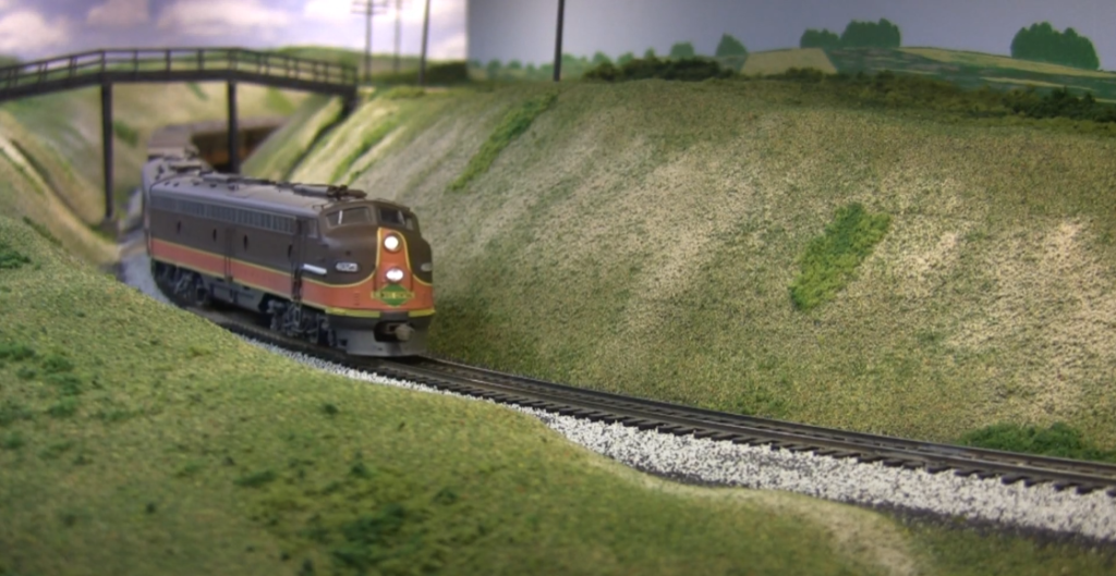 Model locomotive in grassy scene
