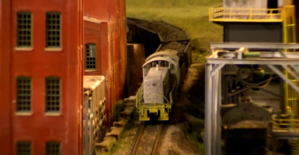 Model locomotive near steel mill