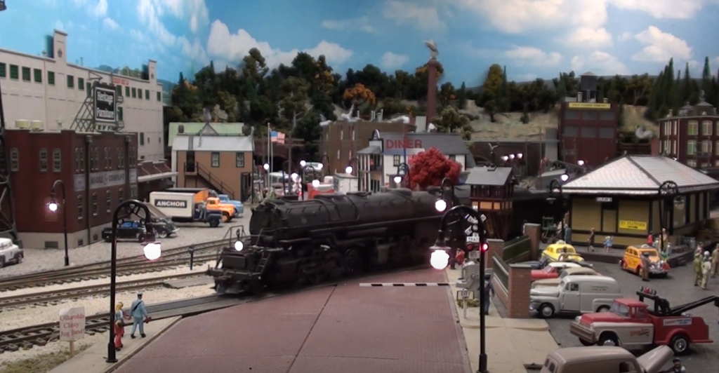 Model locomotive in city scene on layout