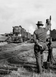 A Southern Ry. conductor watches from a switch stand