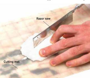 Razor saw cutting piece of Hydrocal