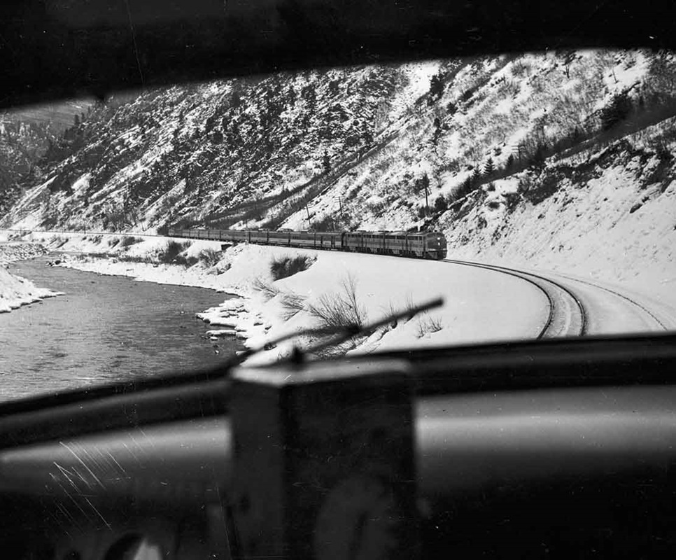 A black and white photo of passenger train