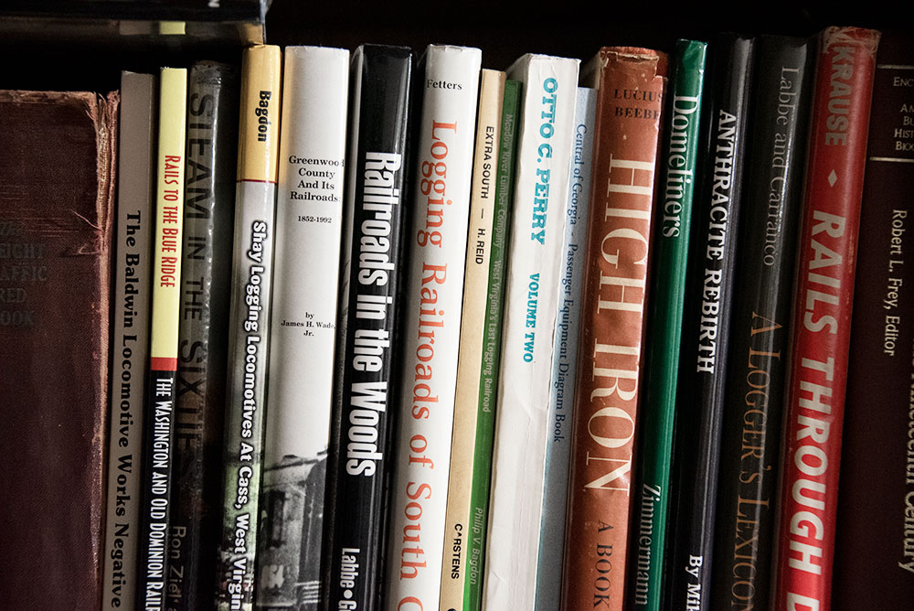 A collection of train books on a bookshelf