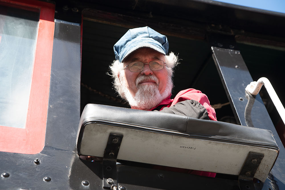 A train engineer looking out the cab window