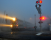 A metra train passing through a stop light