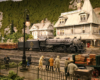 A 2-8-4 steam locomotive model pulls a train through a center of a town depicted in a mountainous, forested landscape.