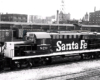 A santa fe train sitting in a rail yard
