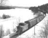 a freight train going off into the distance with a caboose in the foreground on a winter day