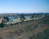 A navy blue and yellow Santa Fe locomotive on the tracks