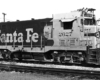 A close up of a santa fe train on the tracks