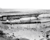 A far away black and white picture of two East- and westbound FT-powered freights trains traveling in opposite directions on a bridge