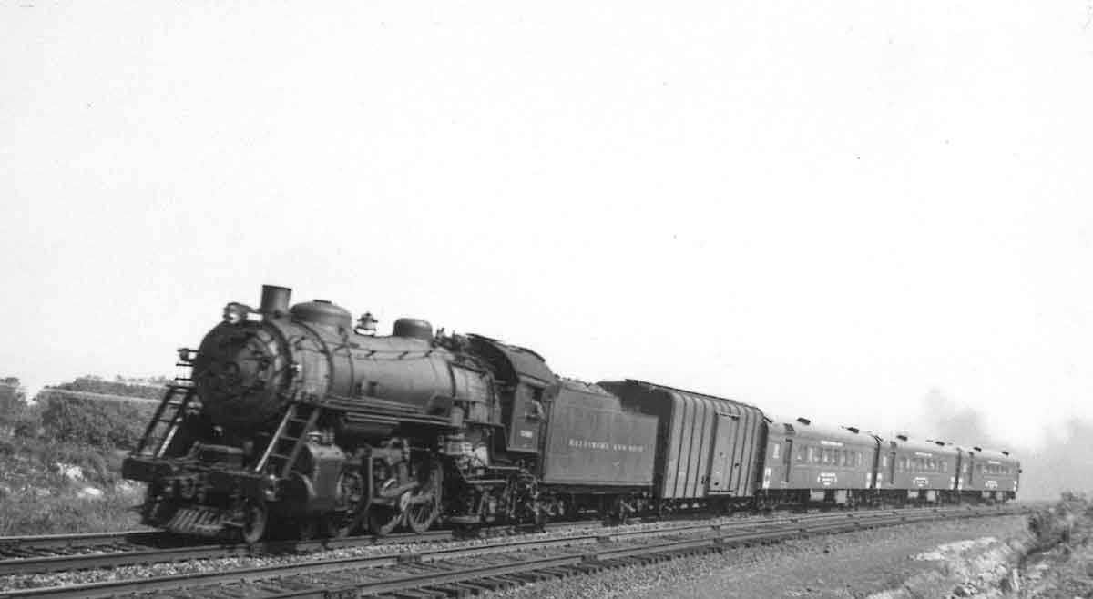 Steam-powered passenger train with boxcar