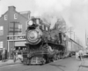 Steam locomotive with passenger train on street trackage