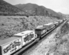 Circus wagons on flatcars in hills