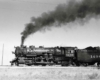 Smoking steam Missouri Pacific locomotives with freight train