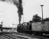 Smoking steam Missouri Pacific locomotives with man on tender