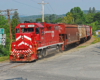 A red train passing through a town