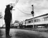 Police officer salutes passing train