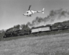 Helicopter paces steam locomotive and train