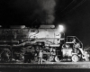 A worker standing outside a train in the dark