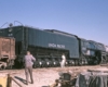 Someone looking up at the Big Boy train as someone else takes their picture