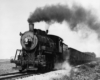 A black and white photo of Pere Marquette 2-8-0 No. 371 with black smoke coming out of its chimney