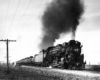 A black and white picture of locomotive 2-8-2 804 on the tracks with black smoke coming out of its chimney