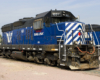 A blue train parked in a rail yard