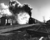 A black and white picture of Berkshire 1220 with its headlight on and smoke coming our of its chimney.