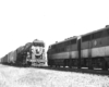A black and white picture of the locomotive Katy F3s waiting behind another locomotive on the tracks