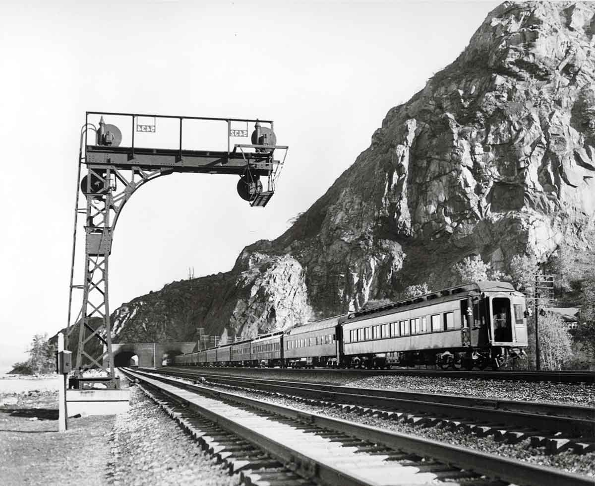 Rear of passenger train by signal cantilever