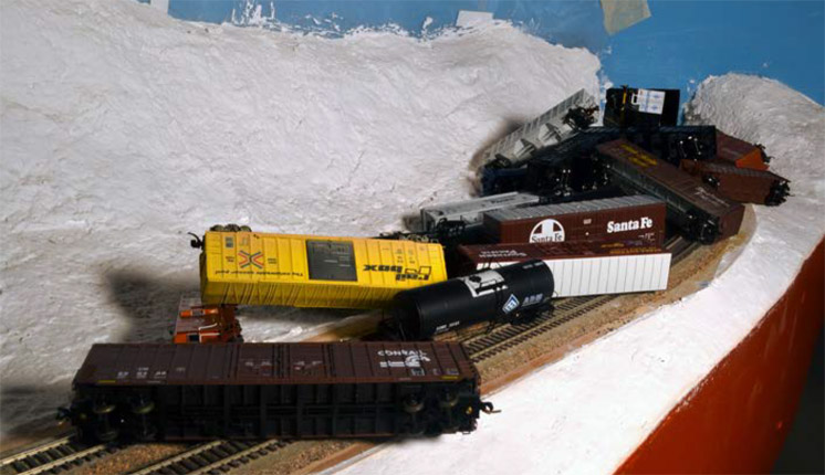 Lessons learned on the helix: An image of crashed model train cars of a model railroad layout