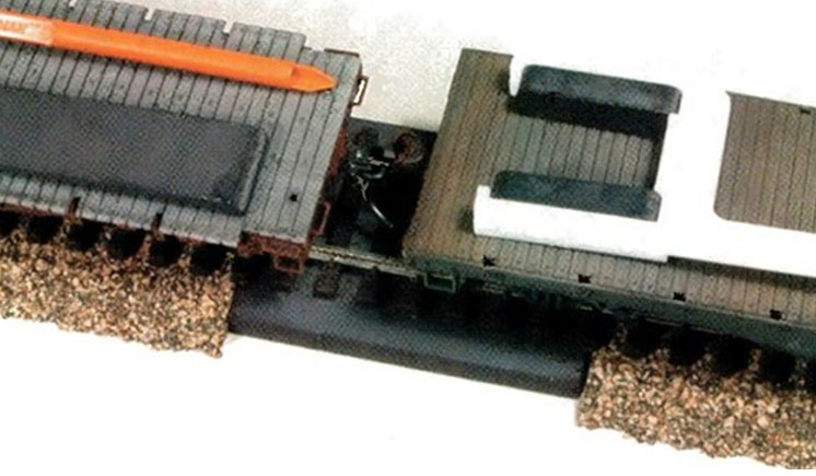 Seven ways to uncouple model railroad train cars: two cars on a ramp