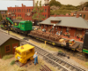 A green-and-black work train in front of a station with passengers. Mostly brick-work downtown.