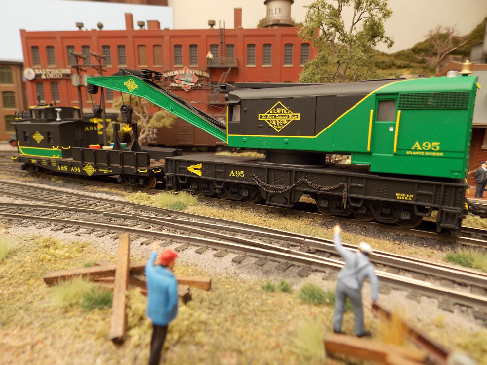 An close up view of a green and black wrecker and work caboose.