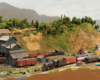 Image of a rural rail yard in a mountainous, arid, verdant landscape with multiple steam locomotives running trains.