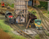 A steam and diesel locomotive operate near a coaling tower and a round table in a verdant rail yard scene.