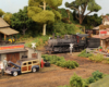 A steam locomotive switcher pulls a train through the outskirts of a small, rural town with dirt roads.