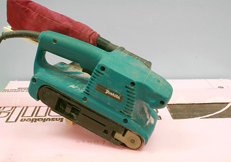 An image of a sander held onto foam board.