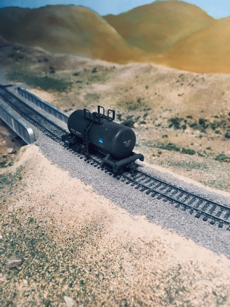 Simplifying body-mounted couplers: A model tank car on a model railroad layout